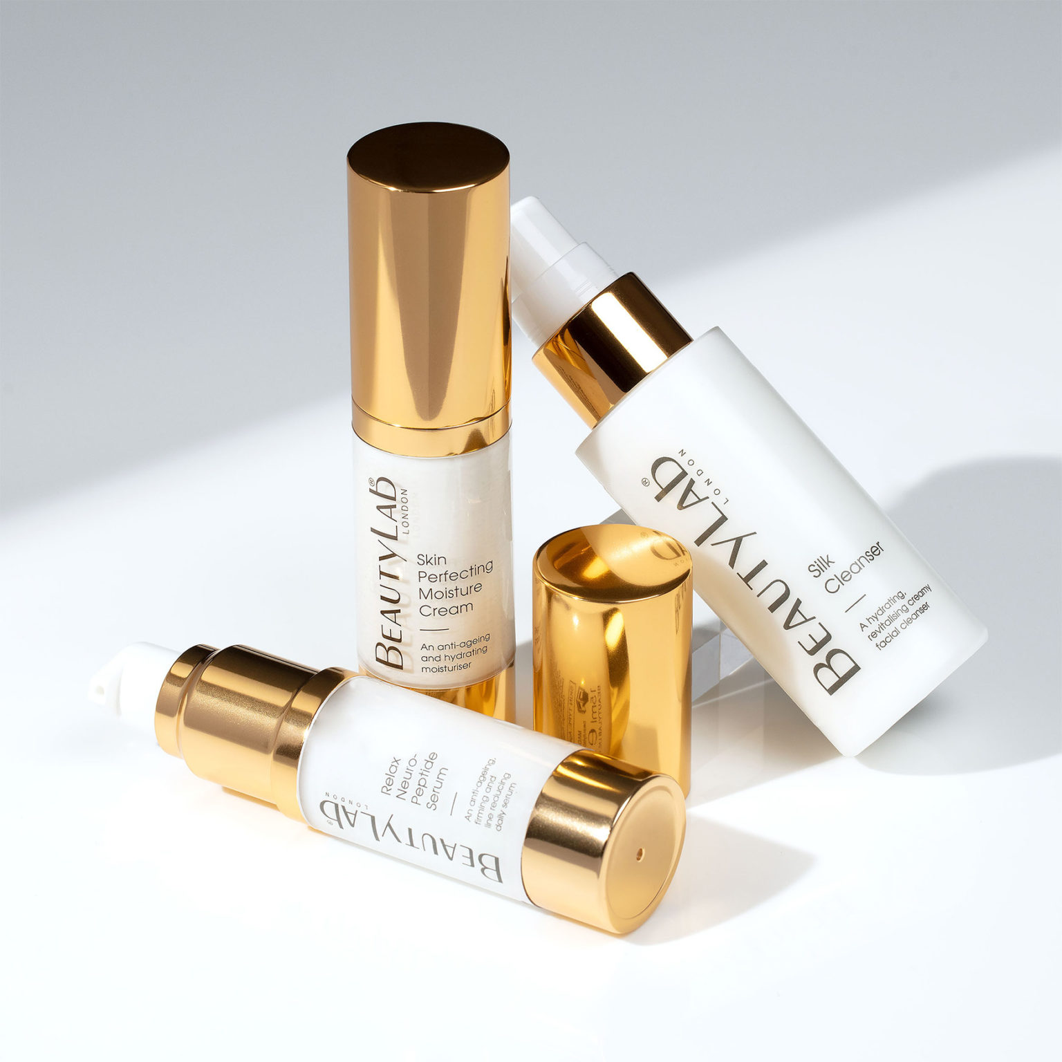 Skin Perfecting Moisture Cream, Silk Cleanser and Relax Neuro-Peptide Serum promped agaisnt a white background