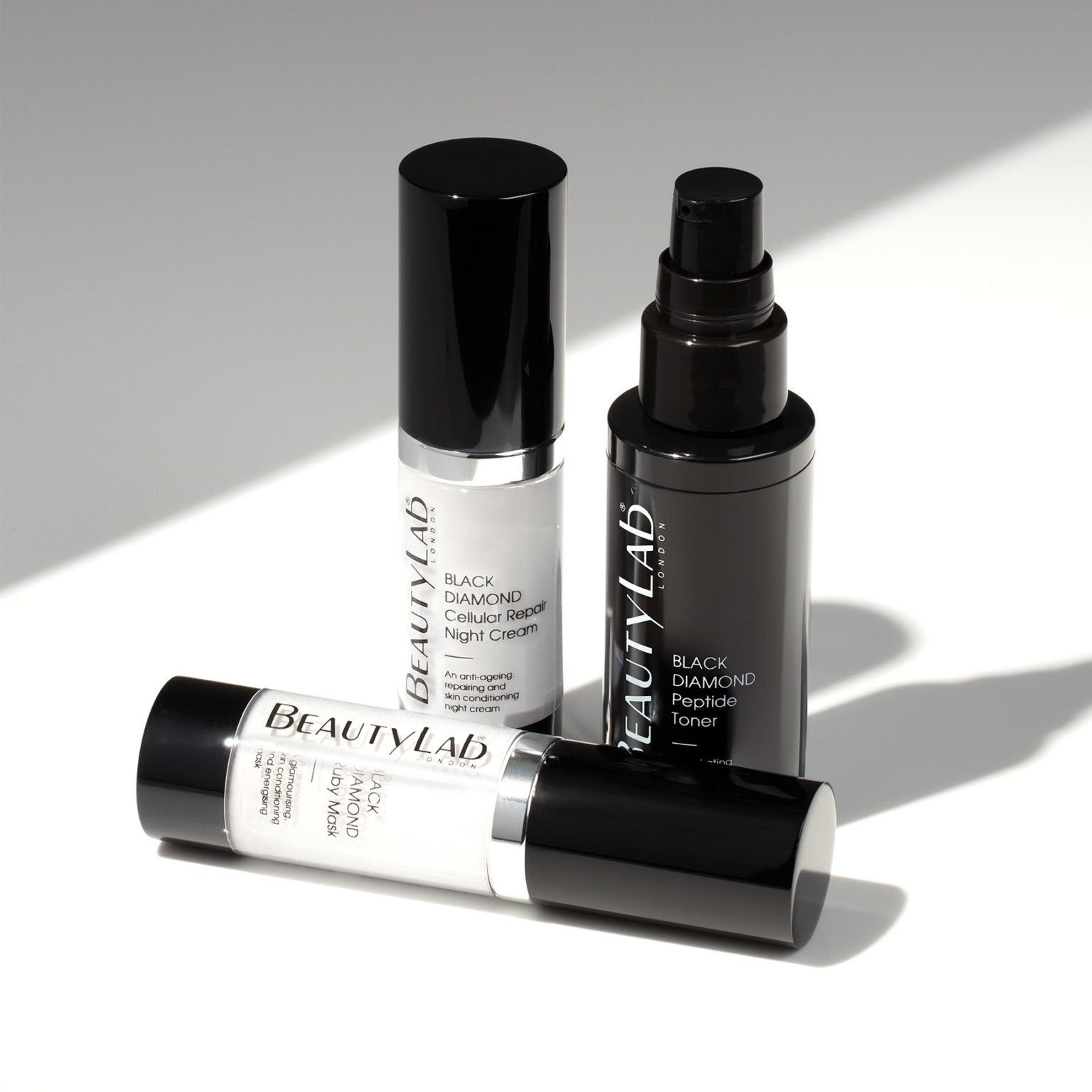 Black Diamond Cellular Repair Night Cream, Black Diamond Peptide Toner and Black Diamond Ruby Mask promped in a white background