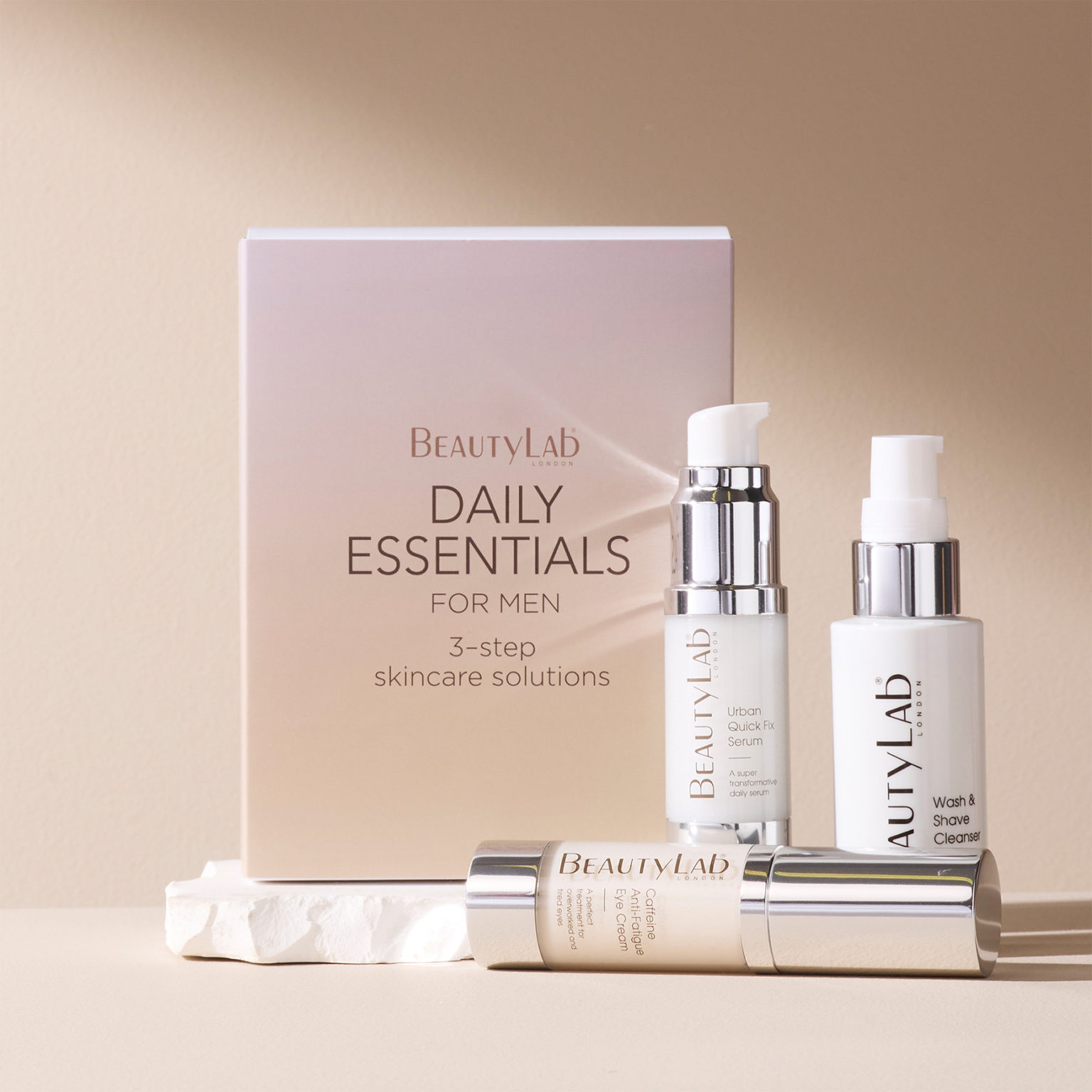 Daily Essentials - Urban Quick Fix Serum, Wash & Shave Cleanser and Caffeine Anti-Fatigue Eye Cream arraged against a pink background