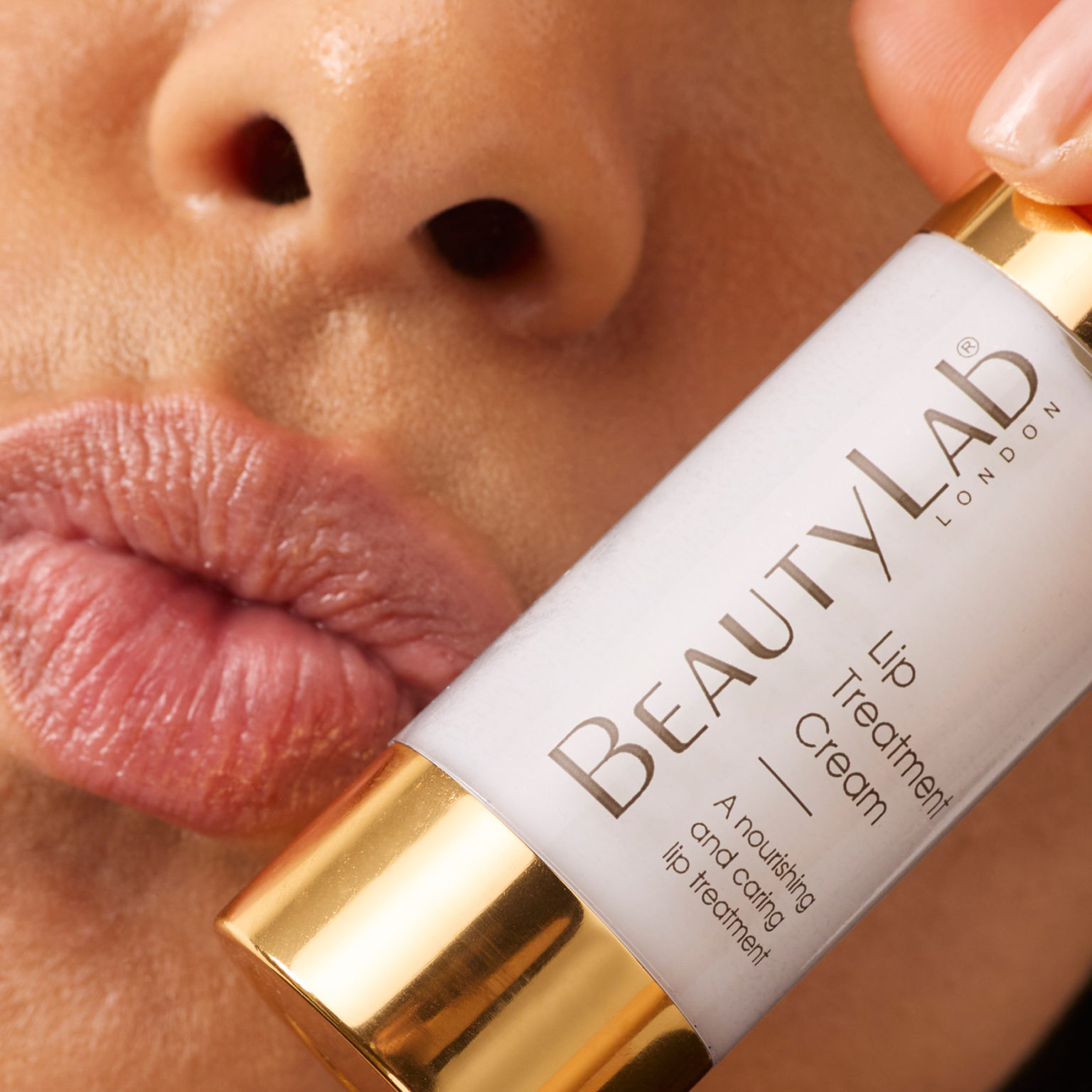 Model holding Lip Treatment Cream