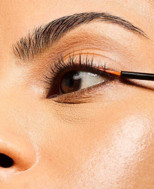 Model aplying Lash Serum onto lashes